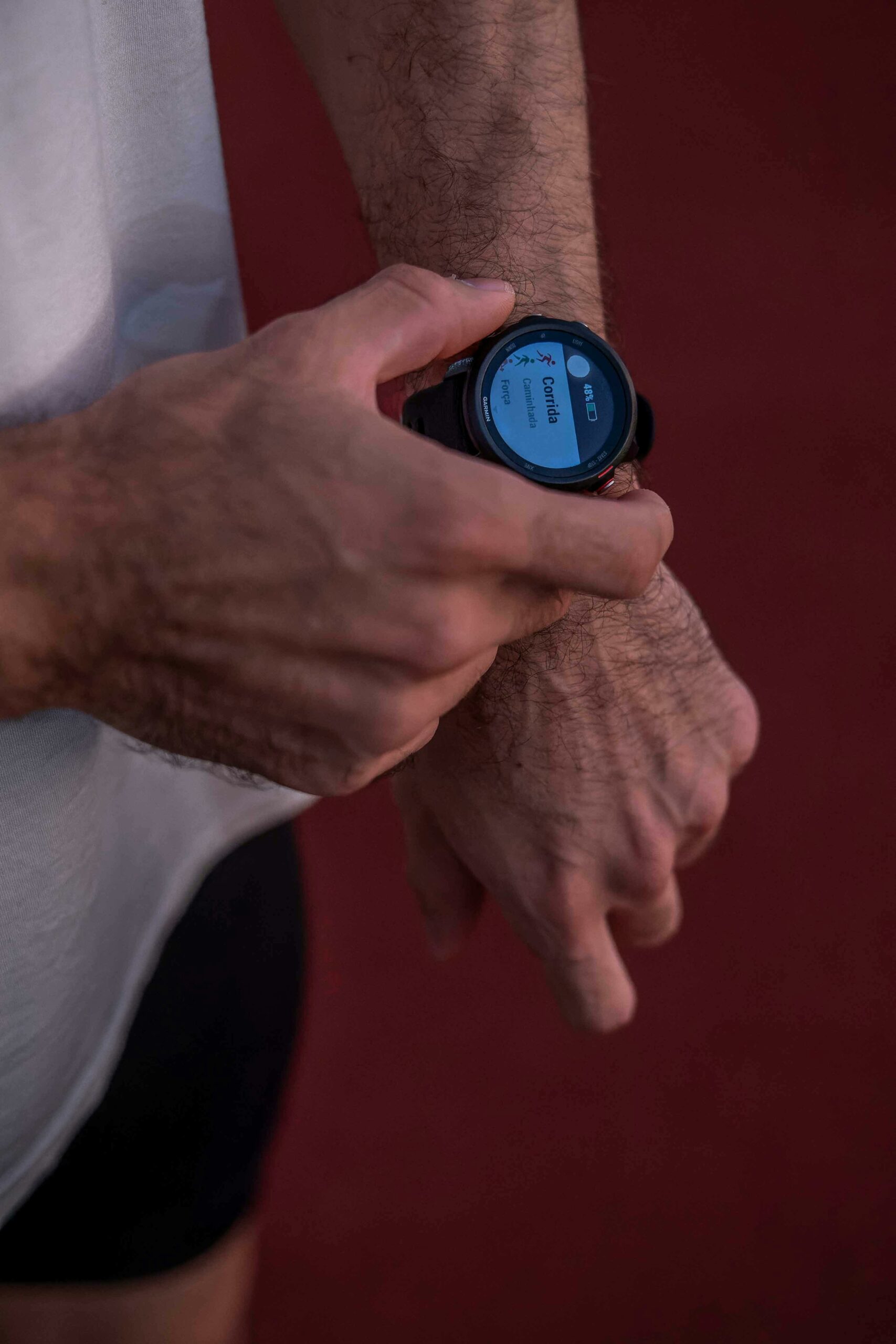 A man checks his smartwatch after a run on an outdoor track in Foz do Iguaçu, Brazil.